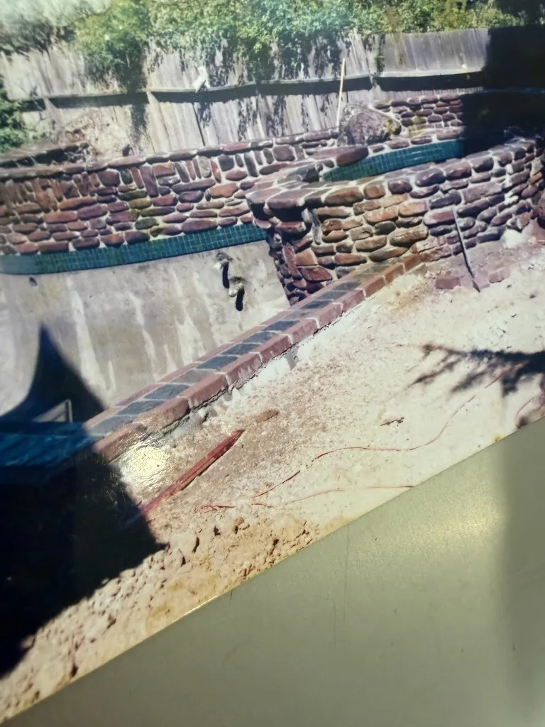 Pool and water feature under construction with stone walls